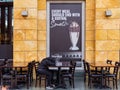 A woman wearing a hijab takes a nap at the empty tables of the closed Hard Rock Cafe restaurant at Resort World Sentosa, Singapore